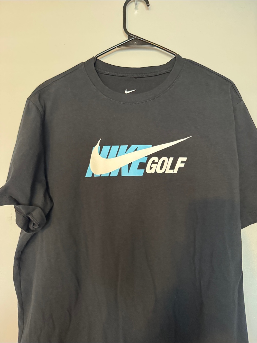 Nike Men's Black Short Sleeve Golf Logo Tee with White Swoosh and Blue Accents